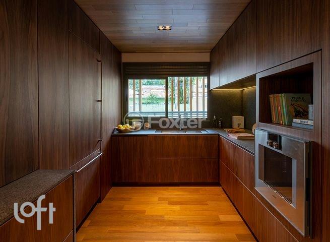 cozinha-moderna-com-armarios-de-madeira-escura-e-vista-para-o-jardim.jpeg