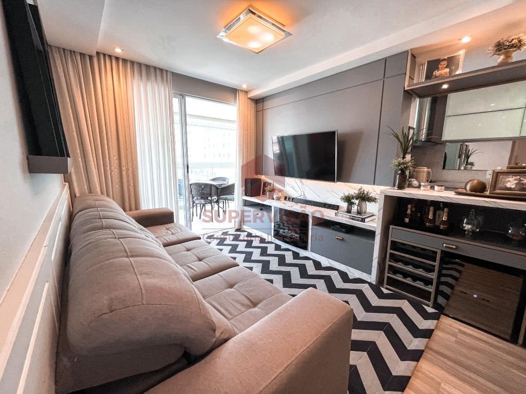 Sala de estar com luminária, rack com painéis, cortinas e decoração estilizada